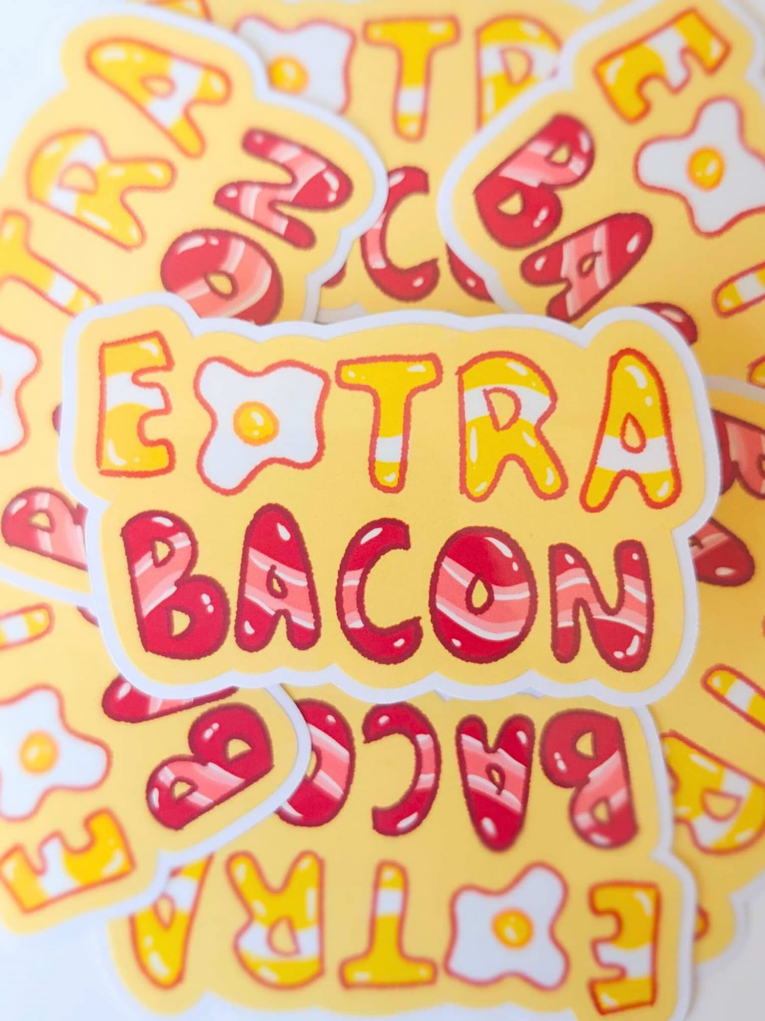 Colorful 'Extra Bacon' text on a yellow background