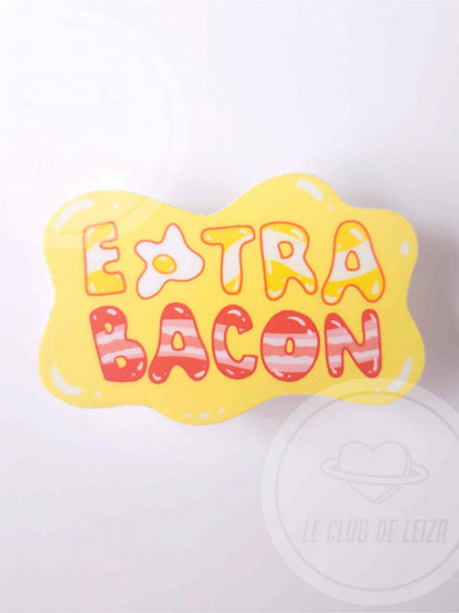 Yellow bone-shaped pillow with 'Extra Bacon' text on a white background
