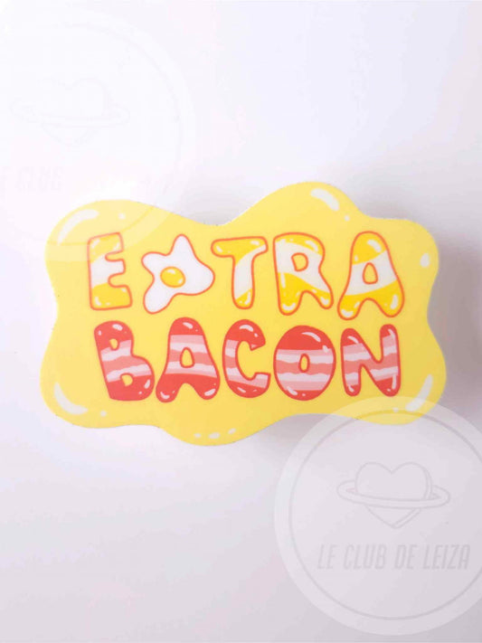 Yellow bone-shaped pillow with 'Extra Bacon' text on a white background