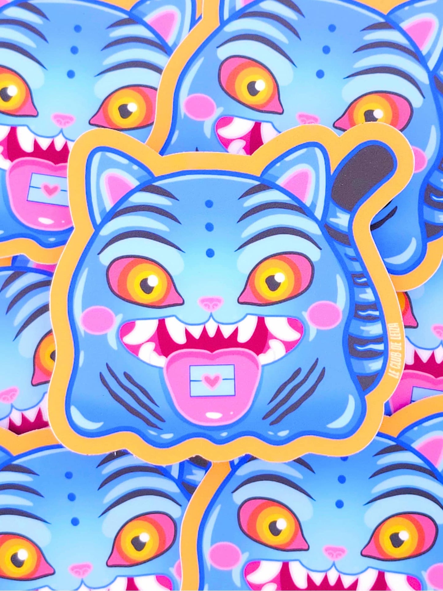 Colorful illustration of a blue cat-like creature with large eyes and a pink heart on a blue background.