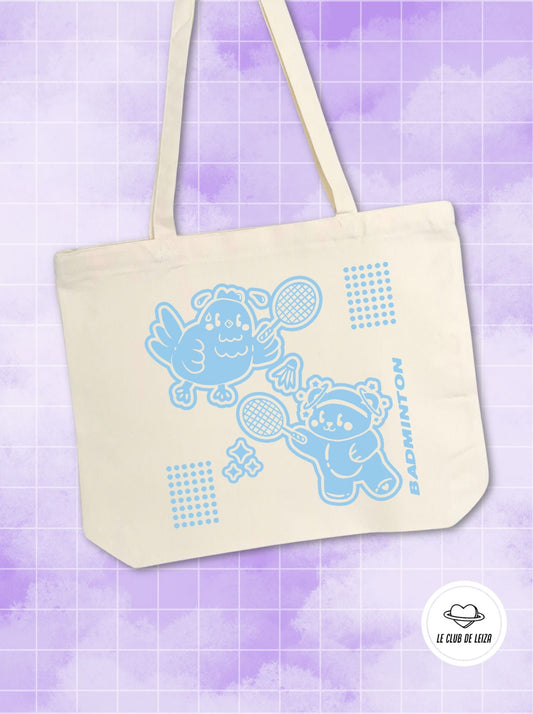 Beige tote bag with blue cartoon characters and patterns on a purple background