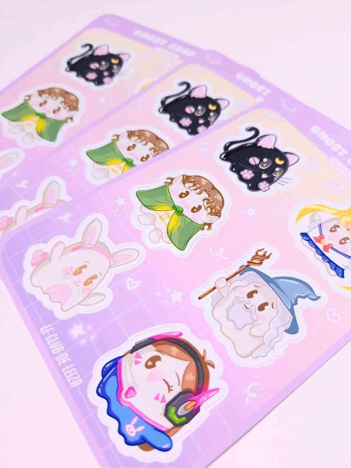 Sheet of cute cartoon stickers with various characters on a pink background
