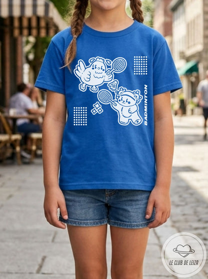 Person wearing a blue t-shirt with white graphics on a street background