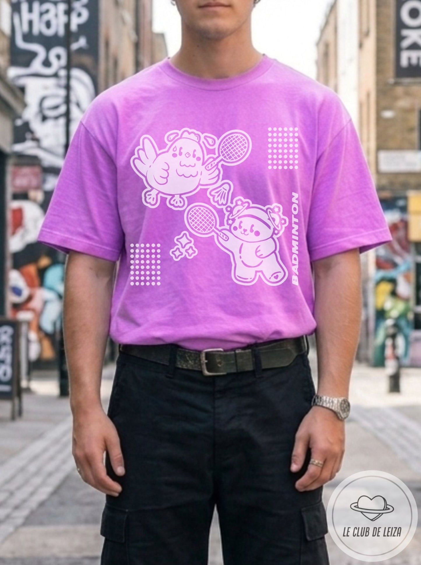 Man wearing a purple t-shirt with cartoon characters in an urban setting