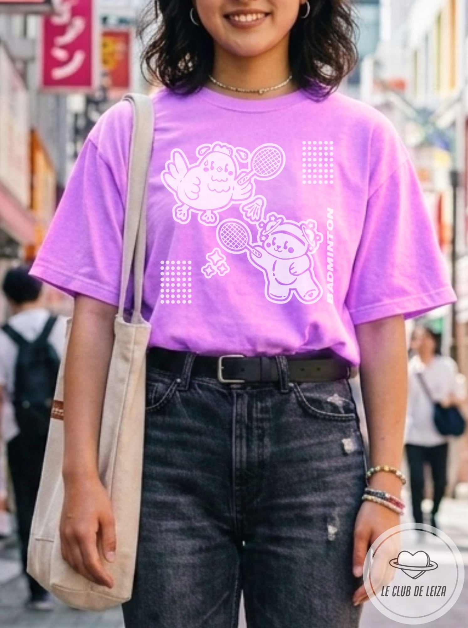 Woman wearing a purple graphic t-shirt in an urban setting